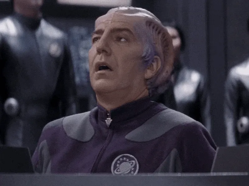 Sir Alexander Dane, Alan Rickman’s character from Galaxy Quest, sighs in
relief and slumps in his chair as a crowd of Thermians applaud
him.
